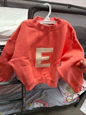 Essentials Coral Sweatshirt with Cream 'E' Graphic